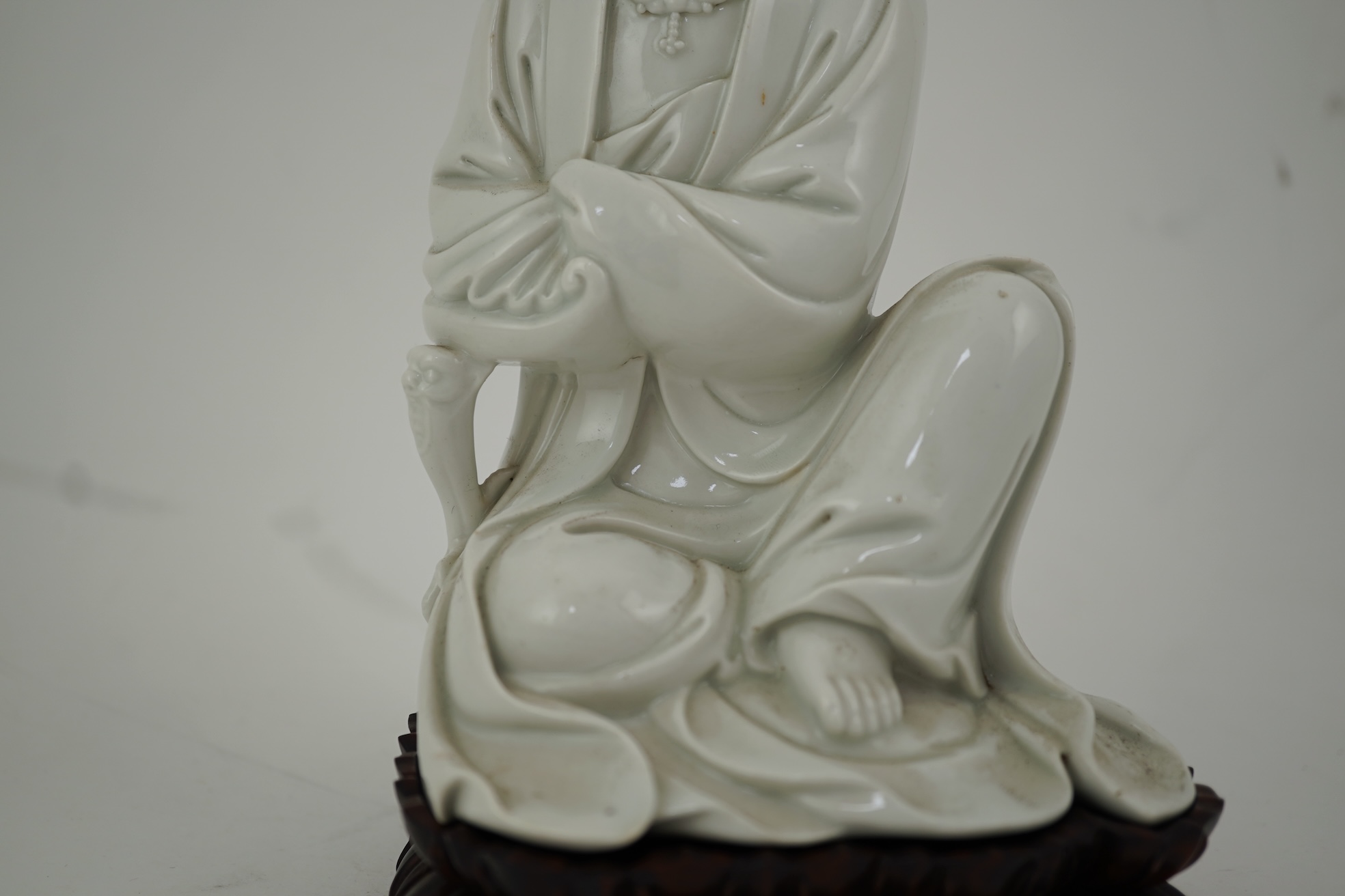 A Chinese blanc-de-chine seated figure of Guanyin, late 19th/early 20th century